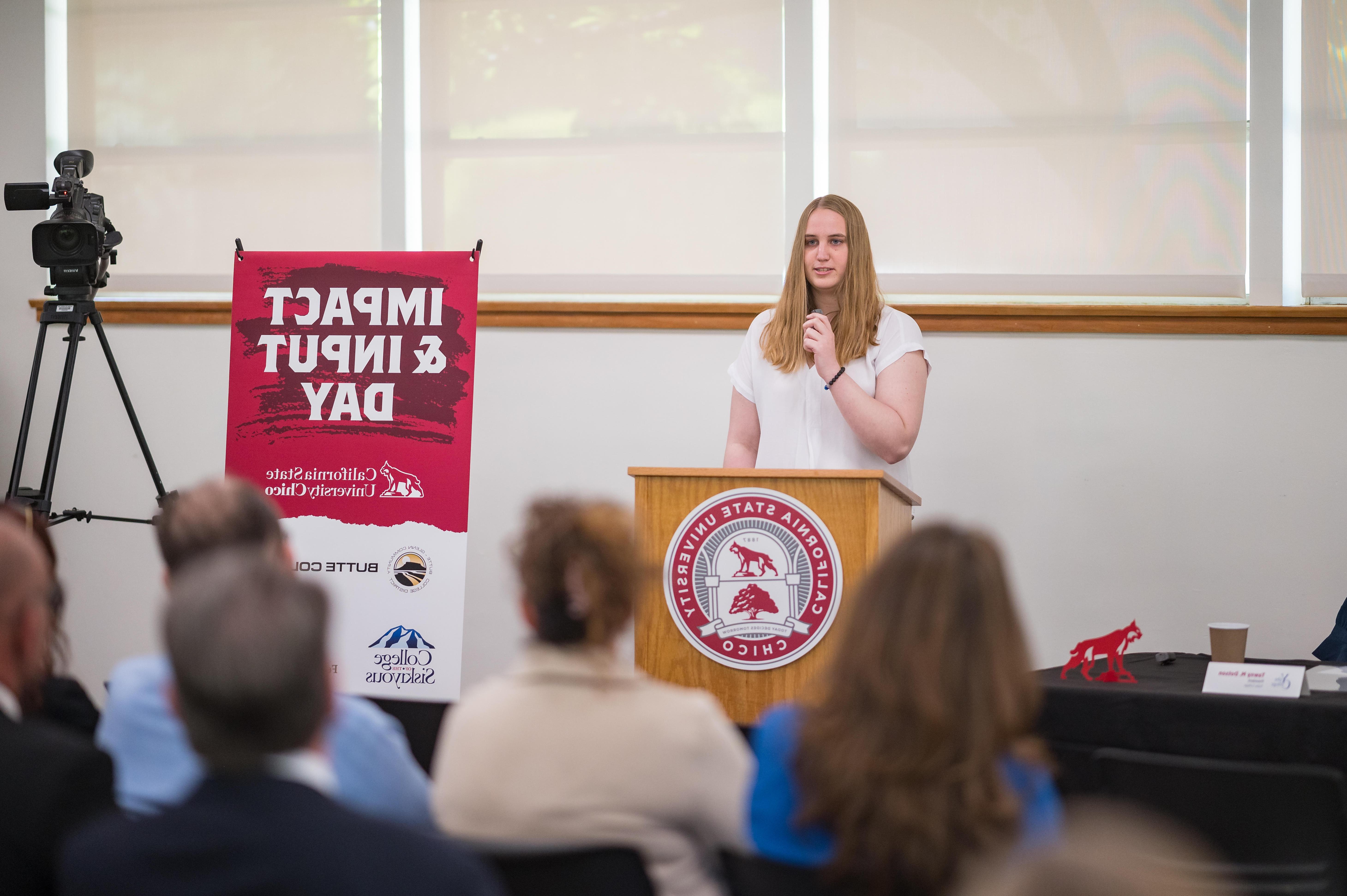 A E世博ESBALL transfer student is show speaking at a podium.